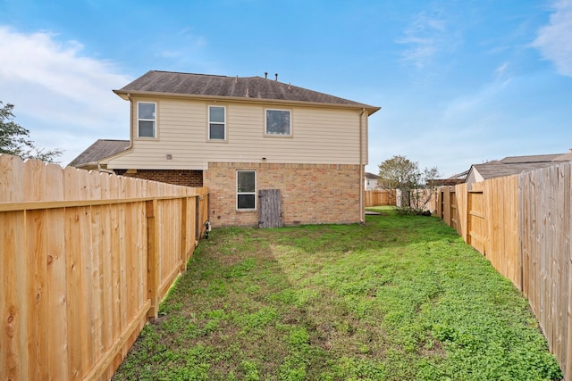 back of house featuring a lawn