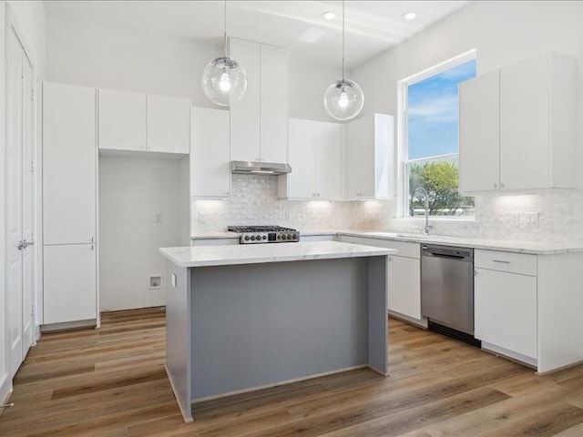 kitchen with white cabinets, sink, pendant lighting, dishwasher, and a center island