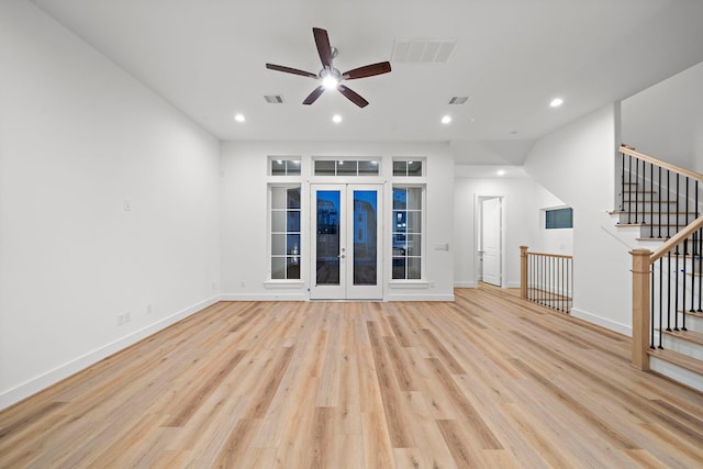 unfurnished living room with ceiling fan, french doors, and light hardwood / wood-style flooring