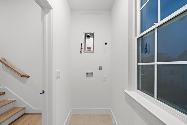 clothes washing area featuring hookup for an electric dryer, hookup for a washing machine, and hookup for a gas dryer