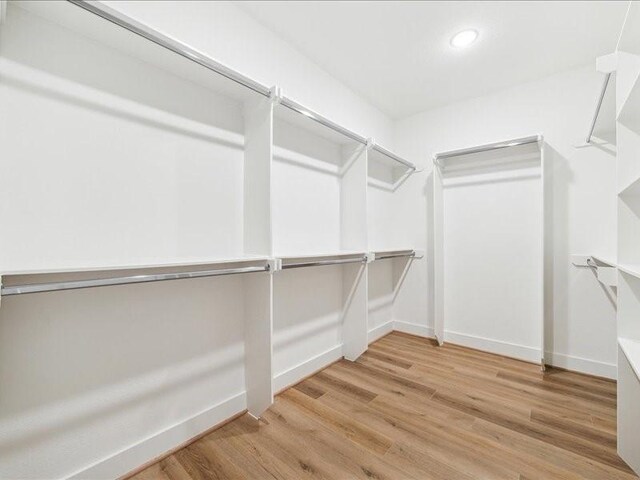 spacious closet with hardwood / wood-style floors