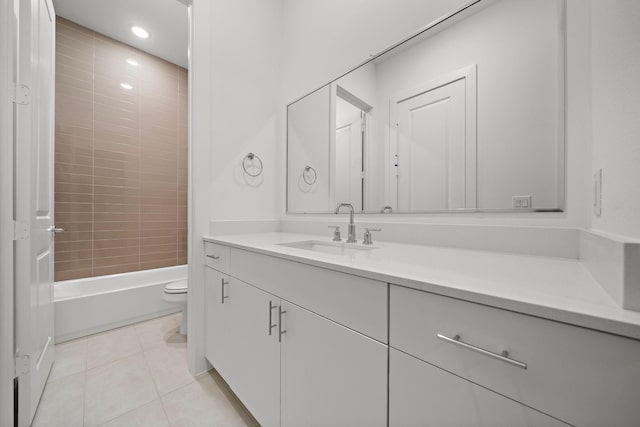 full bathroom featuring tile patterned flooring, vanity, tiled shower / bath combo, and toilet