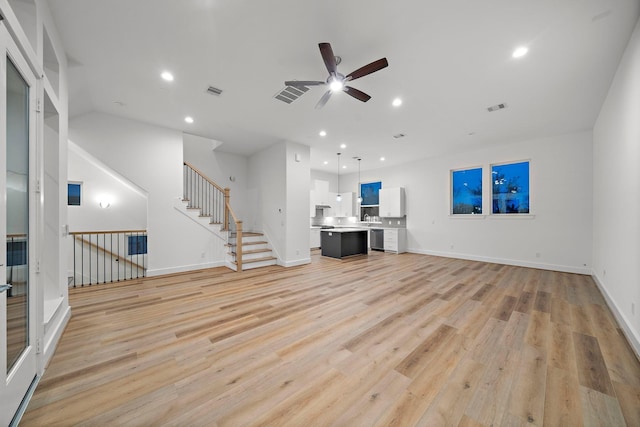 unfurnished living room featuring ceiling fan and light wood-type flooring