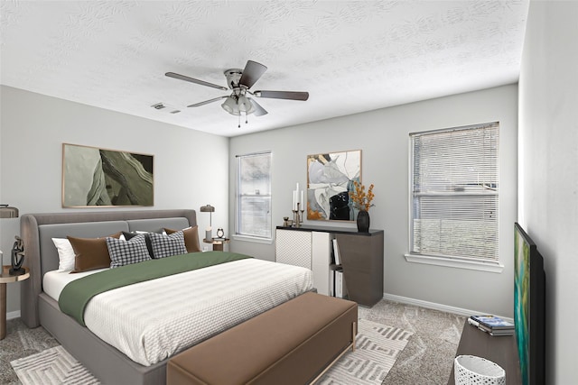 bedroom featuring ceiling fan, light colored carpet, a textured ceiling, and multiple windows