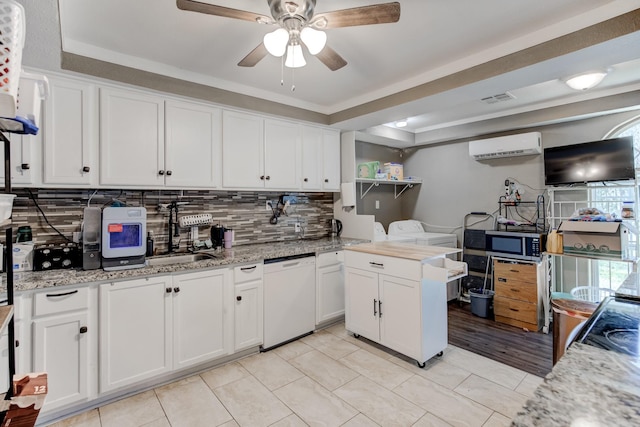 kitchen with white cabinets, white dishwasher, ceiling fan, and light tile patterned flooring