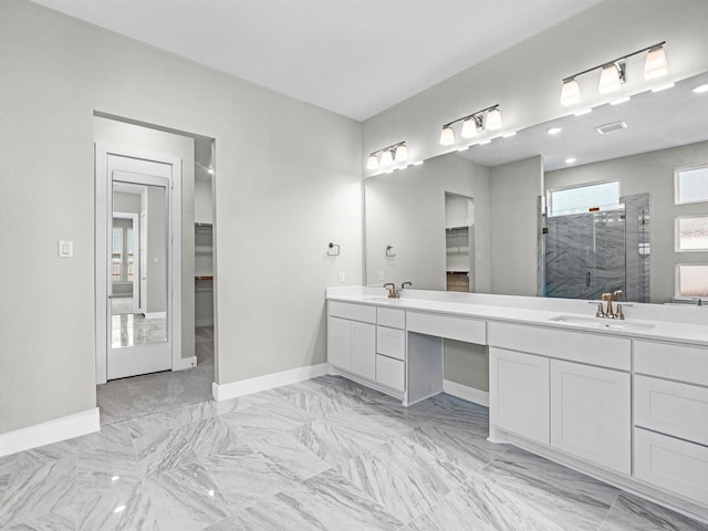 bathroom with a shower with door and vanity