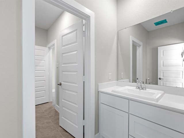 bathroom featuring tile patterned flooring and vanity