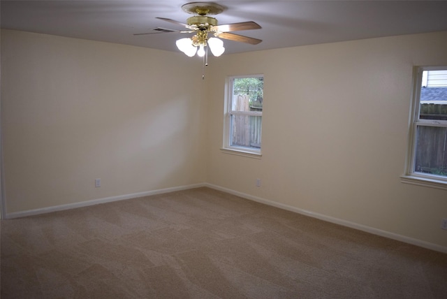 spare room featuring carpet floors and ceiling fan