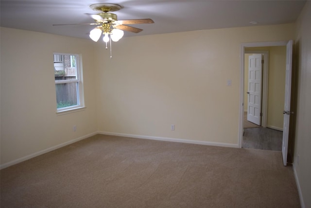 carpeted spare room with ceiling fan