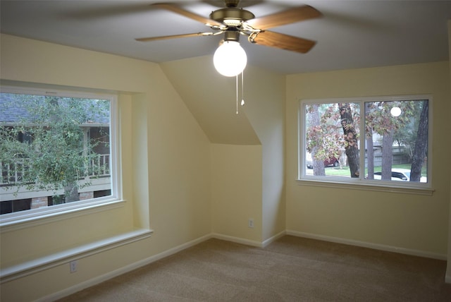 additional living space featuring carpet floors, ceiling fan, and lofted ceiling