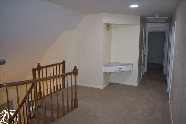 hallway featuring carpet flooring and vaulted ceiling