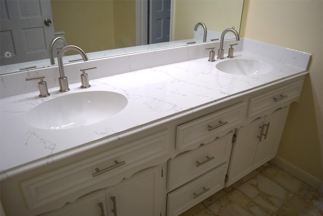 bathroom featuring tile patterned flooring and vanity