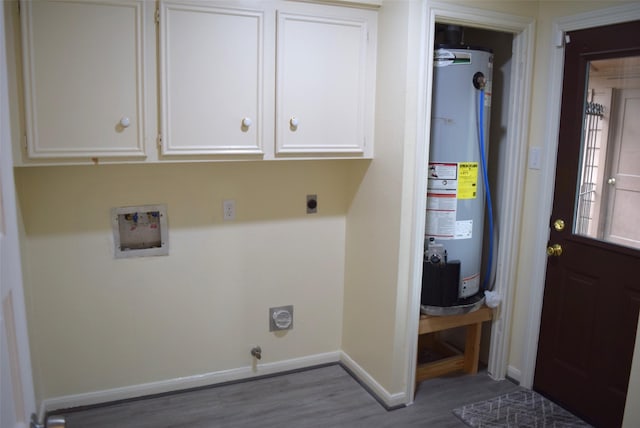 laundry room with electric dryer hookup, dark hardwood / wood-style floors, cabinets, and water heater