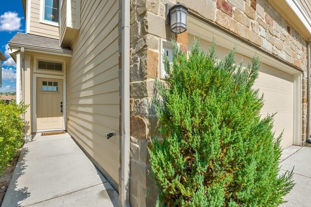 view of exterior entry with a garage