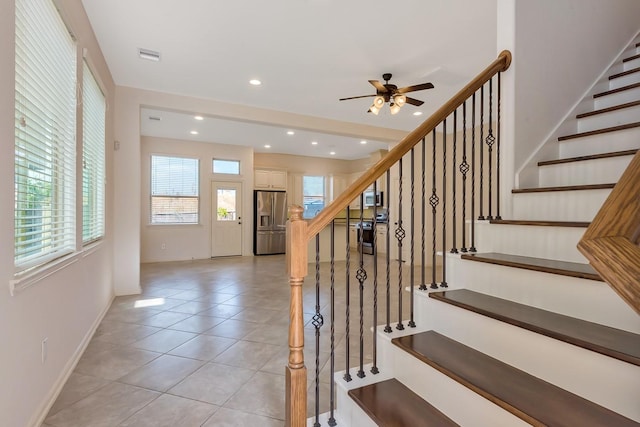 stairway with ceiling fan