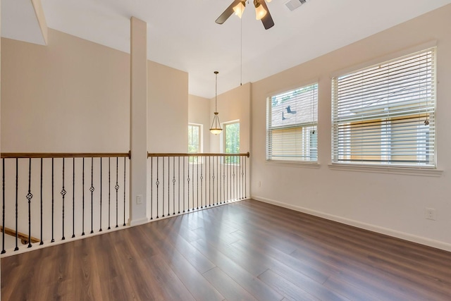 spare room with ceiling fan and dark wood-type flooring