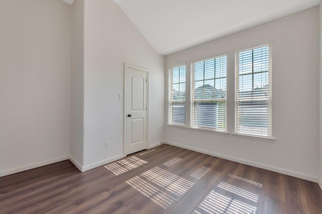 unfurnished room with dark hardwood / wood-style flooring and lofted ceiling