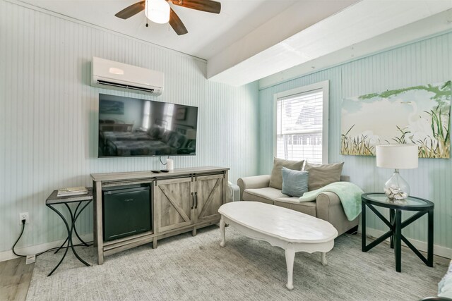 16904 Beachcomber Dr, Galveston, TX 77554 - living room with an AC wall unit, light wood-style floors, and a ceiling fan