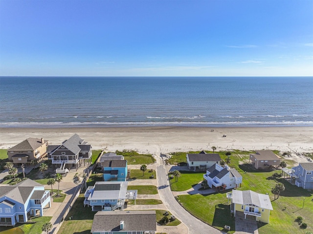 birds eye view of property featuring a water view and a beach view