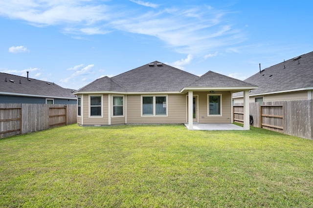 rear view of house with a patio area, ceiling fan, and a yard