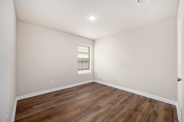 empty room with dark hardwood / wood-style flooring