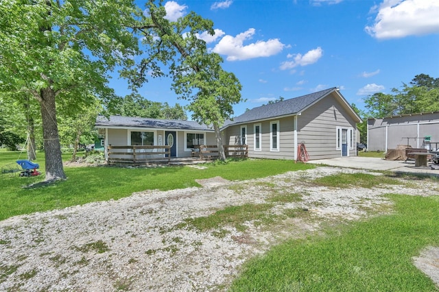 back of house with a lawn