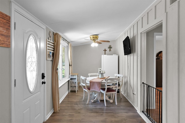 entryway with ceiling fan, dark hardwood / wood-style flooring, and ornamental molding