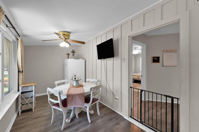 dining space featuring ceiling fan, dark hardwood / wood-style floors, and ornamental molding