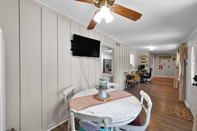 dining area featuring ceiling fan, ornamental molding, and dark wood-type flooring