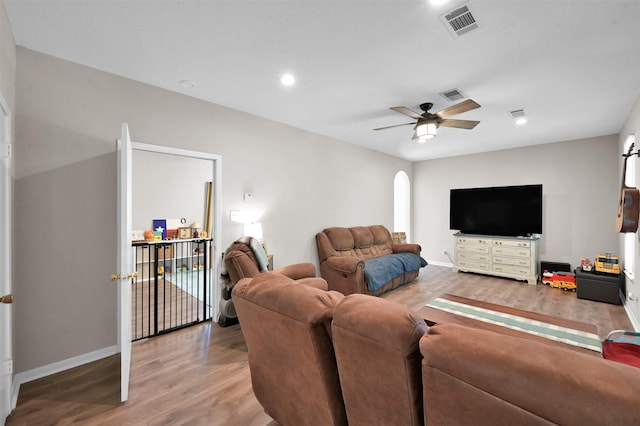 living room featuring ceiling fan and wood-type flooring