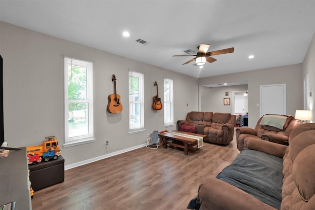 living room featuring hardwood / wood-style flooring and ceiling fan