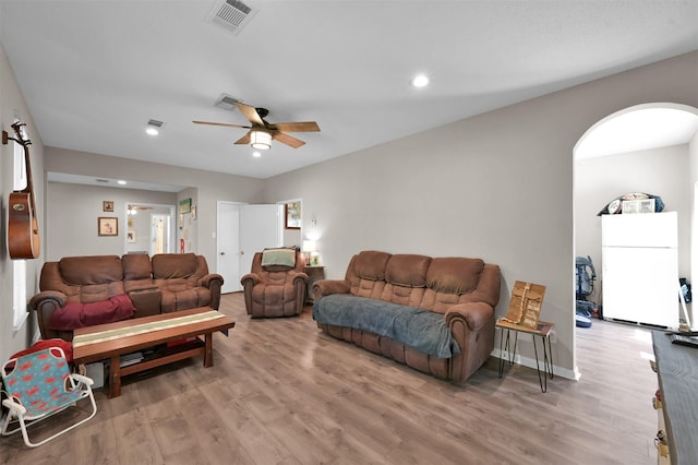 living room featuring ceiling fan and hardwood / wood-style flooring