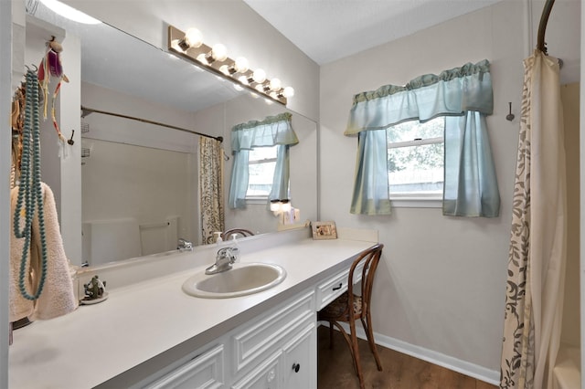 bathroom with hardwood / wood-style floors and vanity