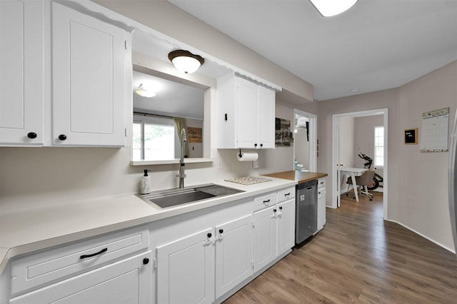 kitchen featuring white cabinetry, dishwasher, light hardwood / wood-style flooring, and sink