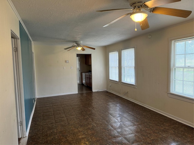 unfurnished living room featuring ceiling fan, crown molding, and a textured ceiling