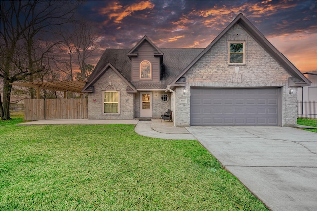 view of front of house featuring a garage and a lawn