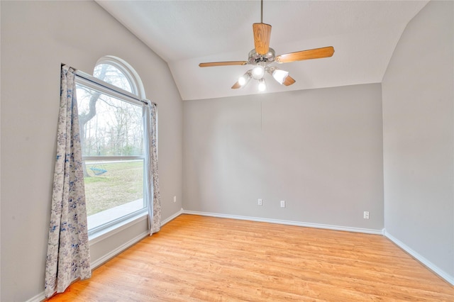 empty room with lofted ceiling, light hardwood / wood-style floors, and ceiling fan