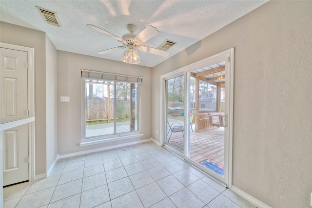 doorway to outside with light tile patterned floors, a textured ceiling, and ceiling fan