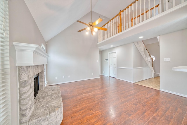 unfurnished living room featuring hardwood / wood-style flooring, high vaulted ceiling, and ceiling fan