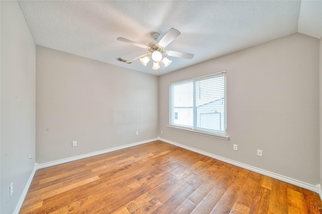 empty room featuring ceiling fan, a textured ceiling, and light wood-type flooring