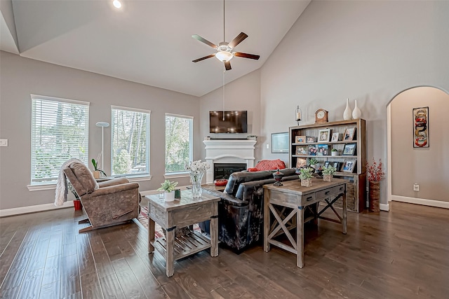 living room with ceiling fan, high vaulted ceiling, and dark hardwood / wood-style floors