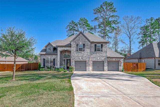 view of front of home with a front yard and a garage