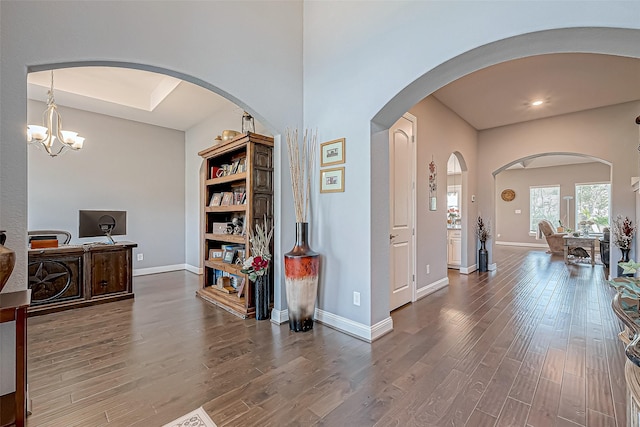 office space with wood-type flooring and a notable chandelier