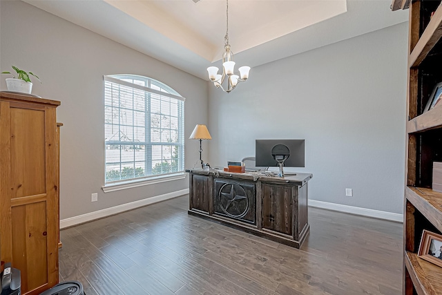 home office featuring a notable chandelier and dark hardwood / wood-style flooring