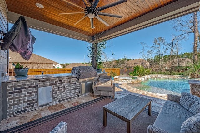 view of patio featuring area for grilling, ceiling fan, and a pool with hot tub