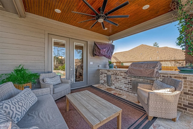 view of patio / terrace with an outdoor kitchen, ceiling fan, and a grill