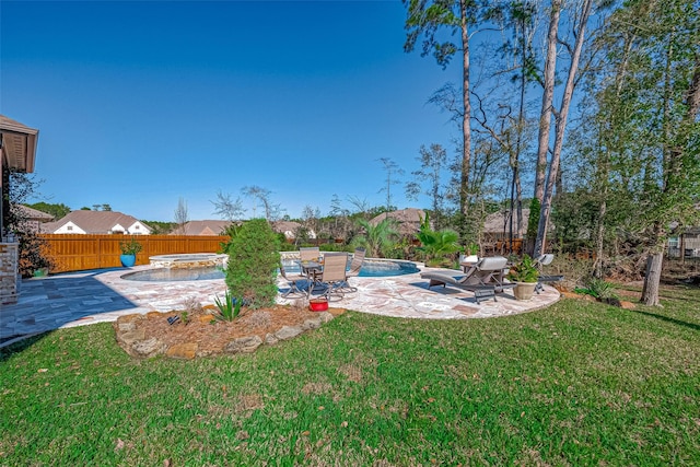 view of yard featuring a patio and a pool with hot tub