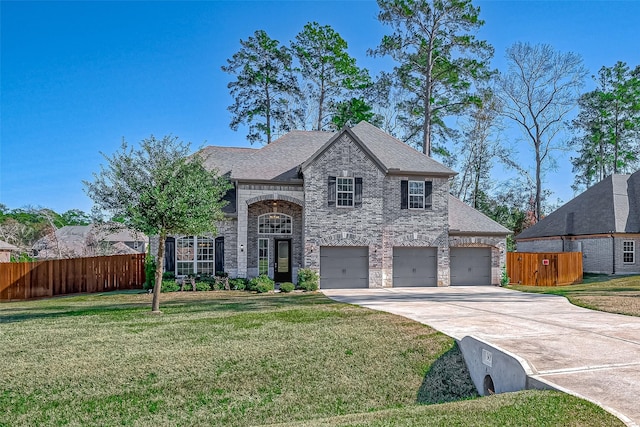 view of front facade featuring a garage and a front lawn