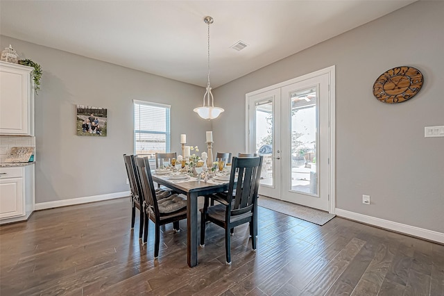 dining room featuring french doors and dark wood-type flooring