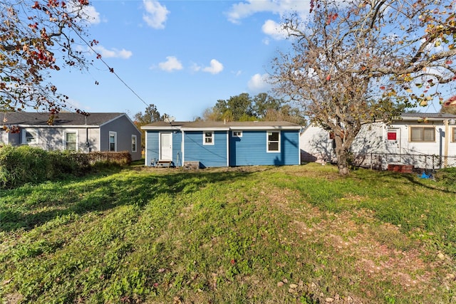 back of property featuring a lawn